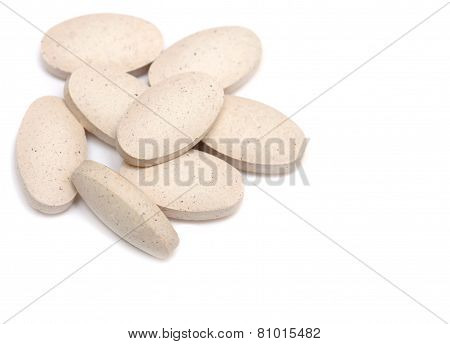 pills. White tablets in bulk isolated on white background