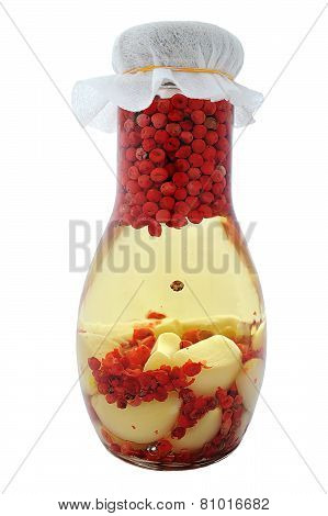 Infused olive oil with pink pepper and garlik.  Isolated