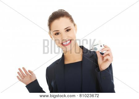 Young businesswoman with plane toy in hand