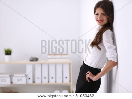 Attractive businesswoman with her arms crossed stnding