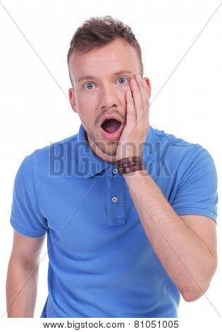 picture of a young casual man with a shocked expression on his face. isolated on a white background