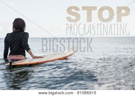 Rear view of a woman with surfboard in the water against stop procastinating