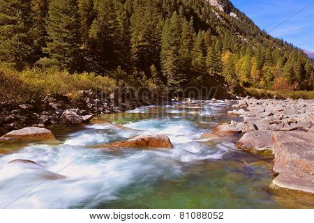 Pastoral in the Alpine mountain valley in Austria. Rapid mountain stream. Cascades of cold water at the source of the famous Krimml waterfalls