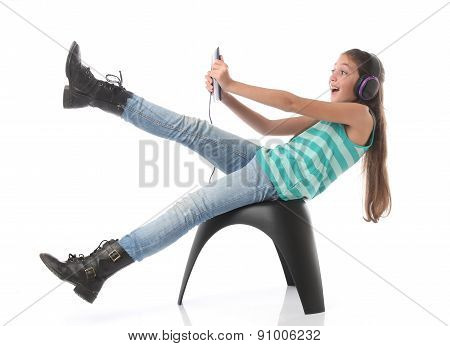 Beautiful pre-teen girl going crazy with a tablet computer