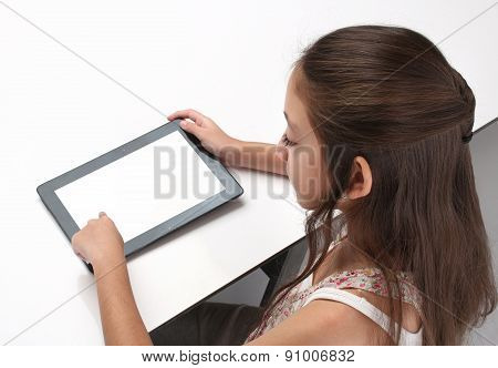 Beaitiful pre-teen girl using a tablet computer.