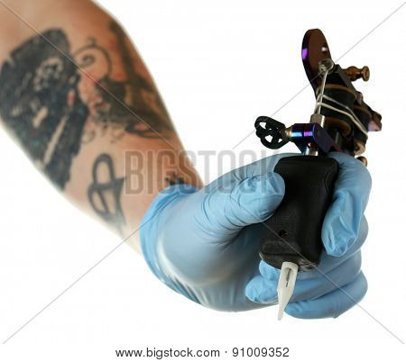Hand of tattoo artist with tattoo machine isolated on white