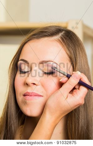 Makeup artist paints the eyebrows model. painting of eyebrows.