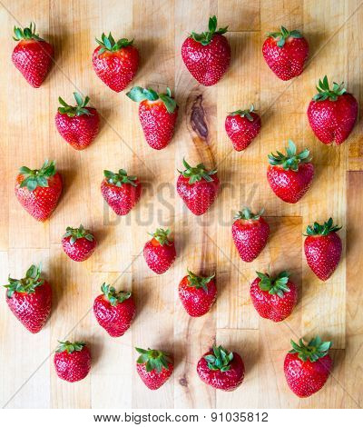 Arranged Pattern Of Strawberries On A Wooden Board