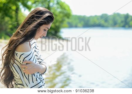 pretty girl on the beach look at water