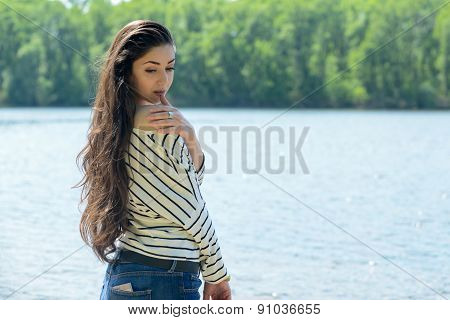 pretty girl on the beach look at water