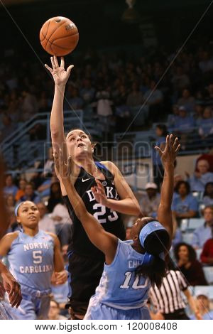 CHAPEL HILL, NC-FEB 28: Duke Blue Devils guard Rebecca Greenwell (23) shoots as University of North Carolina Tar Heels guard Jamie Cherry (10) defends on February 28, 2016 at Carmichael Arena.