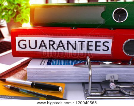 Guarantees on Red Ring Binder. Blurred, Toned Image.