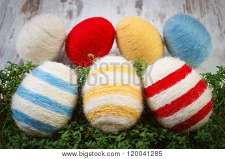 Easter Eggs Wrapped Woolen String And Green Cress On Wooden Background, Decoration For Easter