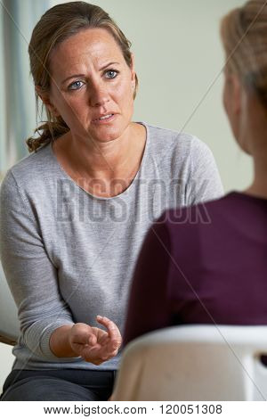 Mature Woman Discussing Problems With Counselor