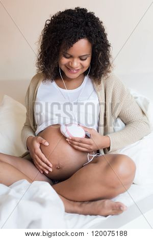 Woman Using A Fetal Doppler At Home