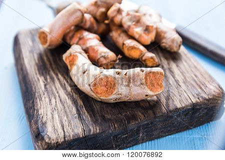 Garden Fresh Tumeric Spice Root On Wooden Board