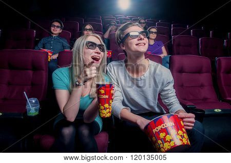 People in the cinema wearing 3d glasses