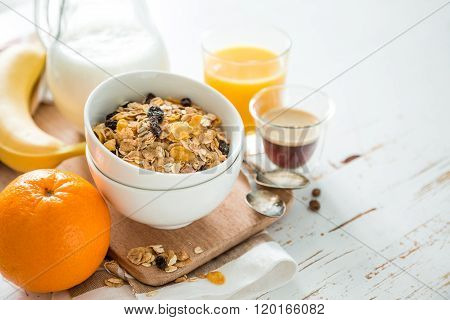 Breakfast - muesli and fruits on white background