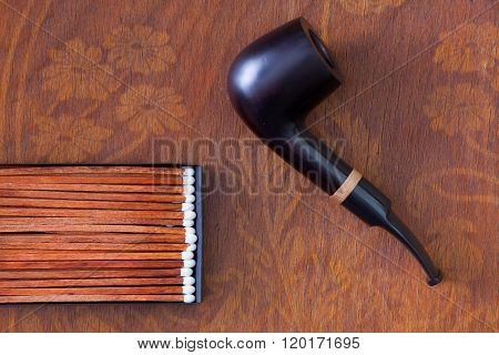 Luxury tobacco pipe on the wooden table