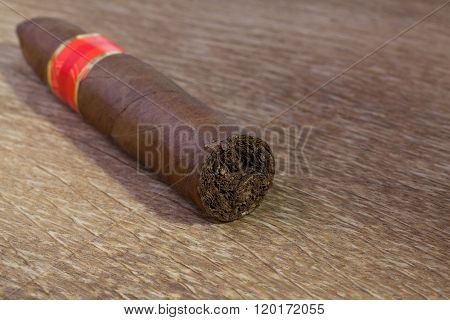 Luxury cuban cigar on the very old wooden table