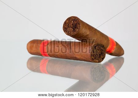 Different Cigars On A  Glass Desk