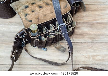 Old Hunting Cartridge In Bandoleer On A Wooden Table