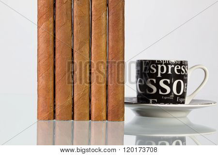 Different cigars and cup of coffee on a glass table and white background