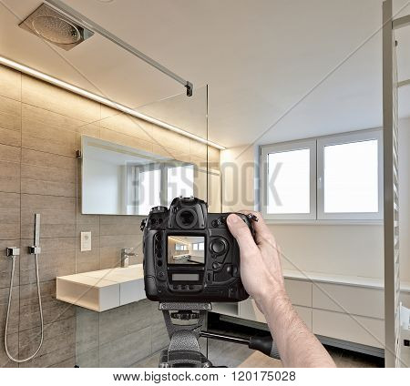 Hands Holding A Professional Camera On Tripod Taking Picture