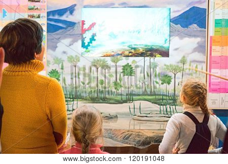 Listvianka, Russia - February 15, 2016: Rear View Of People Looking Prehistoric Trees At Baikal Limn