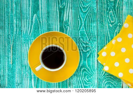 cup of black tea on yellow plate