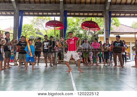 UBUD, BALI / INDONESIA - MAR 1, 2016: Unidentified teenagers at the time of preparations for Ngrupuk parade, which takes place on the eve of Nyepi day in Bali. Nyepi is a public holiday in Indonesia.