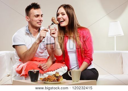 Smiling Man Feeding Happy Woman With Cake.