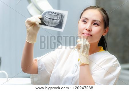 Dentist looking at x-ray picture