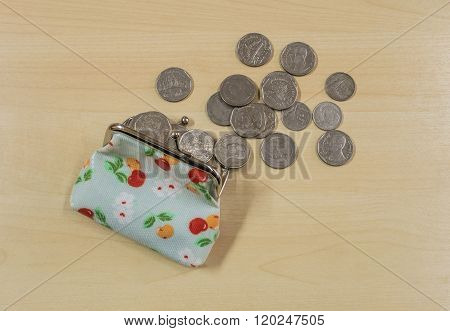 Coins With Open Money Bag On Wood Desk Background