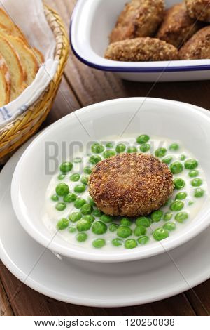 green peas fozelek (thich vegetable stew) and fasirt (fried meatball), hungarian cuisine