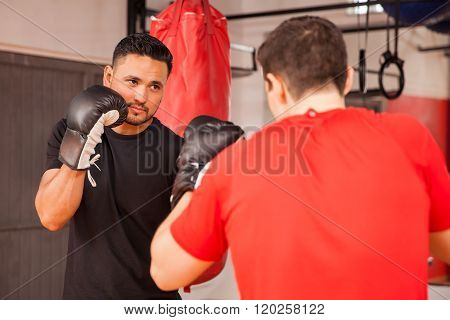 Male Friends Practicing Boxing At A Gym