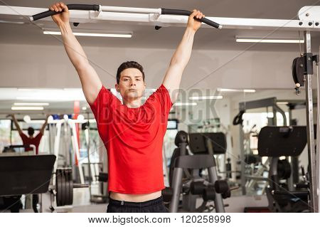 Hispanic Man Doing Some Pullups At A Gym
