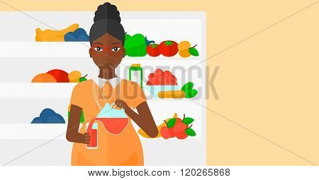 Pregnant woman standing near friedge.