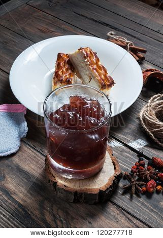 Berry drink. Kissel in glasses with cheese casserole and spices on wood