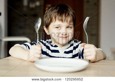 Happy Little Boy Waiting For Dinner.