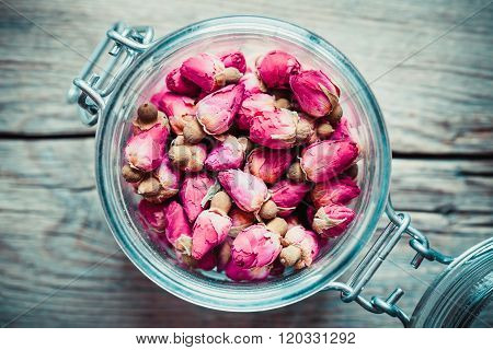 Dry Rose Buds Tea In Glass Jar. Top View.
