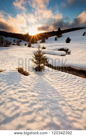 Sun Down Over Mountain River In Winter