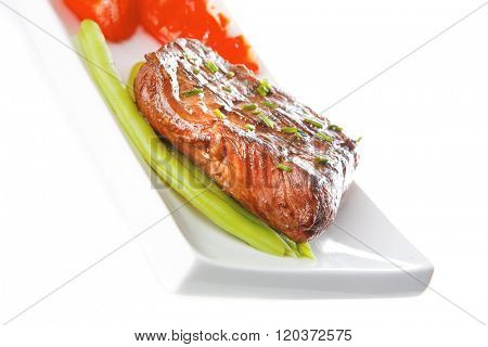 beef meat served with tomato on white porcelain