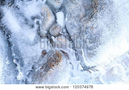transparent ice with air bubbles and stones