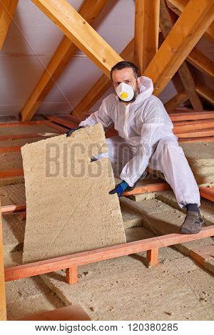 Man Installing Thermal Isnulation With Mineral Whool Panels
