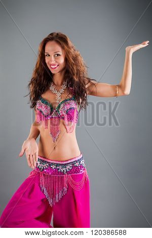 Girl In Pink Orient Dance Costume Poses On Leg