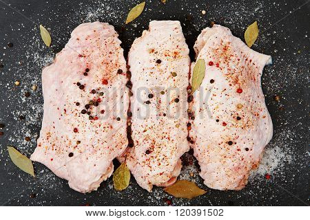 Raw Turkey Wings With With Spices On Black Slate Tray