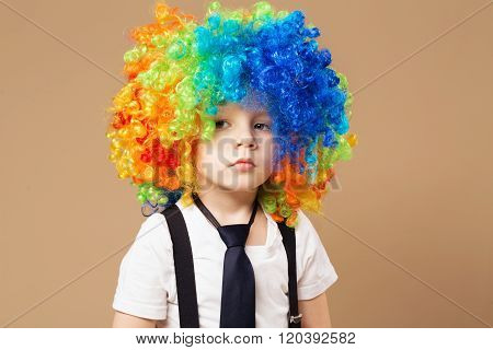 Sad Clown Boy With Large Colorful Wig.