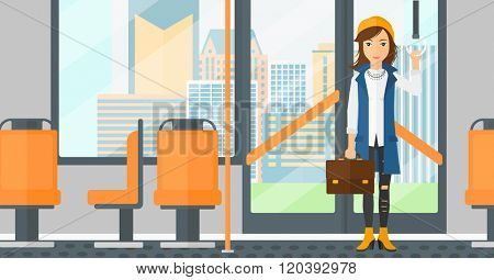 Woman standing inside public transport.