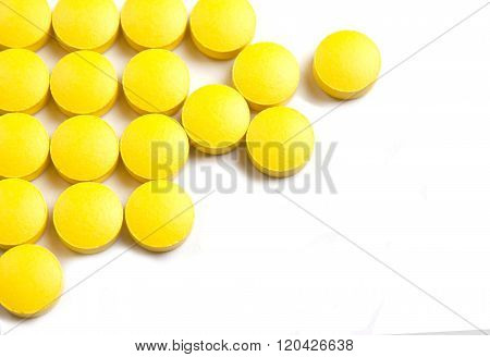 Yellow Pills  On A White Background
